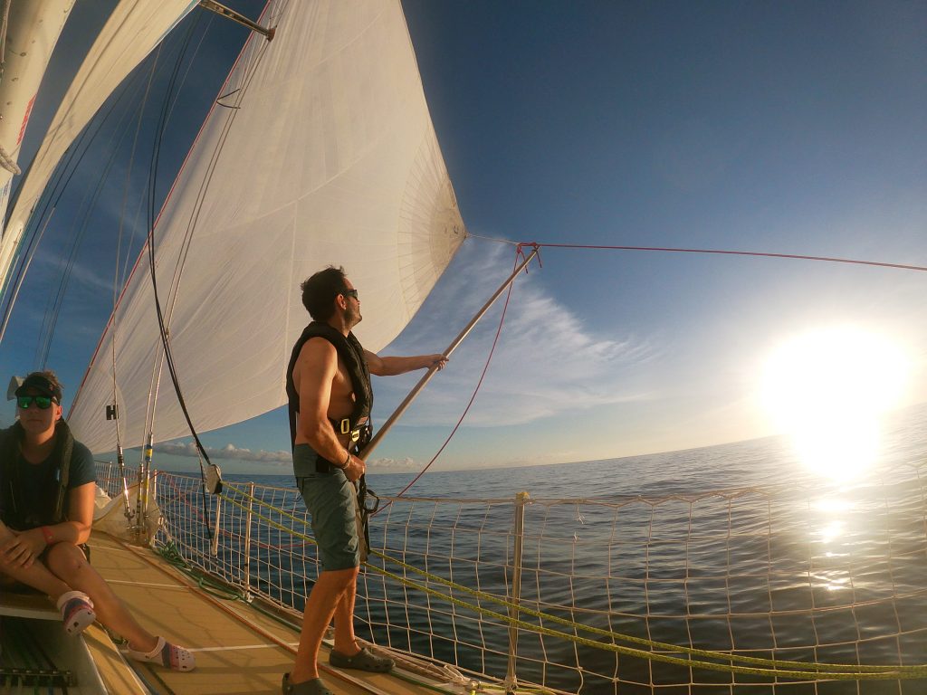 Mike using a boat hook as a spinnaker pole to keep the windseeker filled in 1kt of wind / Sophie Owles